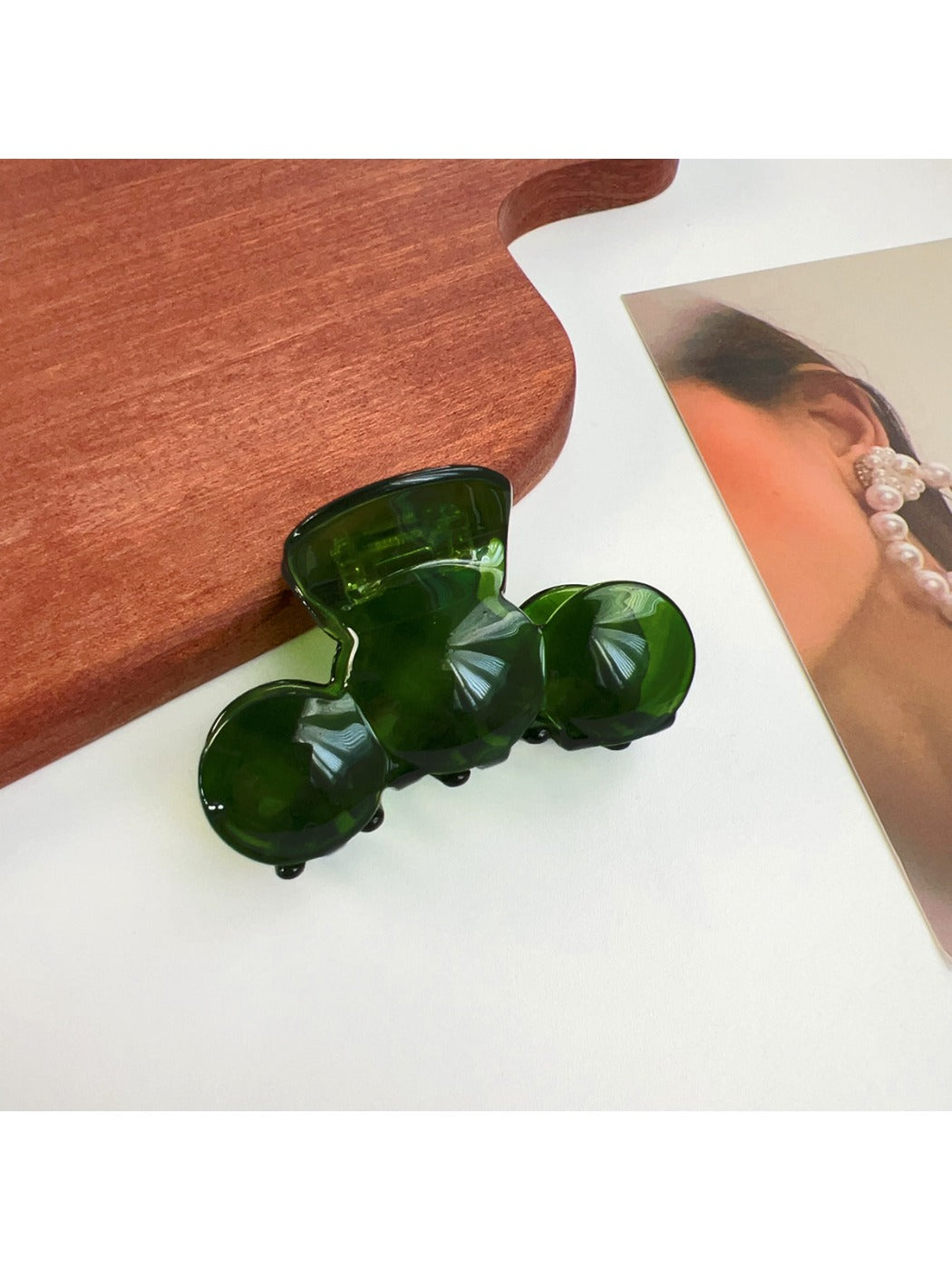 Beau hair claw clip with wavy design placed next to a mirror