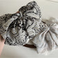 Beau chiffon bow shaped claw clip displayed open to show claw teeth