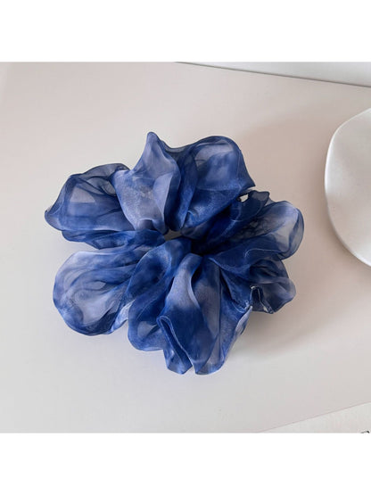 Top view of multi color tulle scrunchie highlighting gathered fabric design