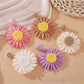 Pair of vintage raffia sunflower earrings displayed on a white background