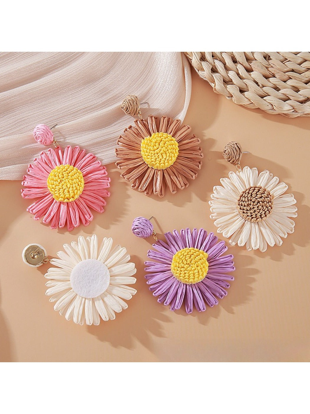 Pair of vintage raffia sunflower earrings displayed on a white background