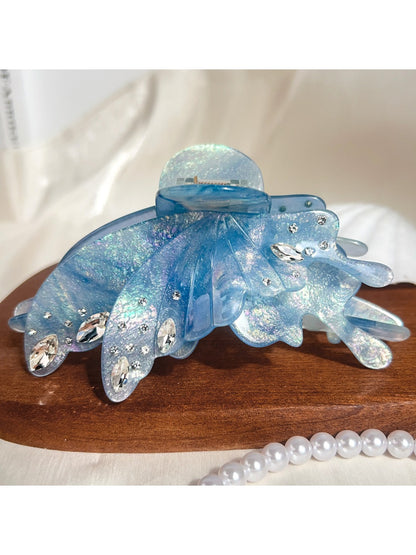 Butterfly hair claw clip with bright colors against a neutral background