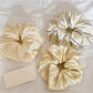 Yellow scrunchie with white and orange stripe print on a white background