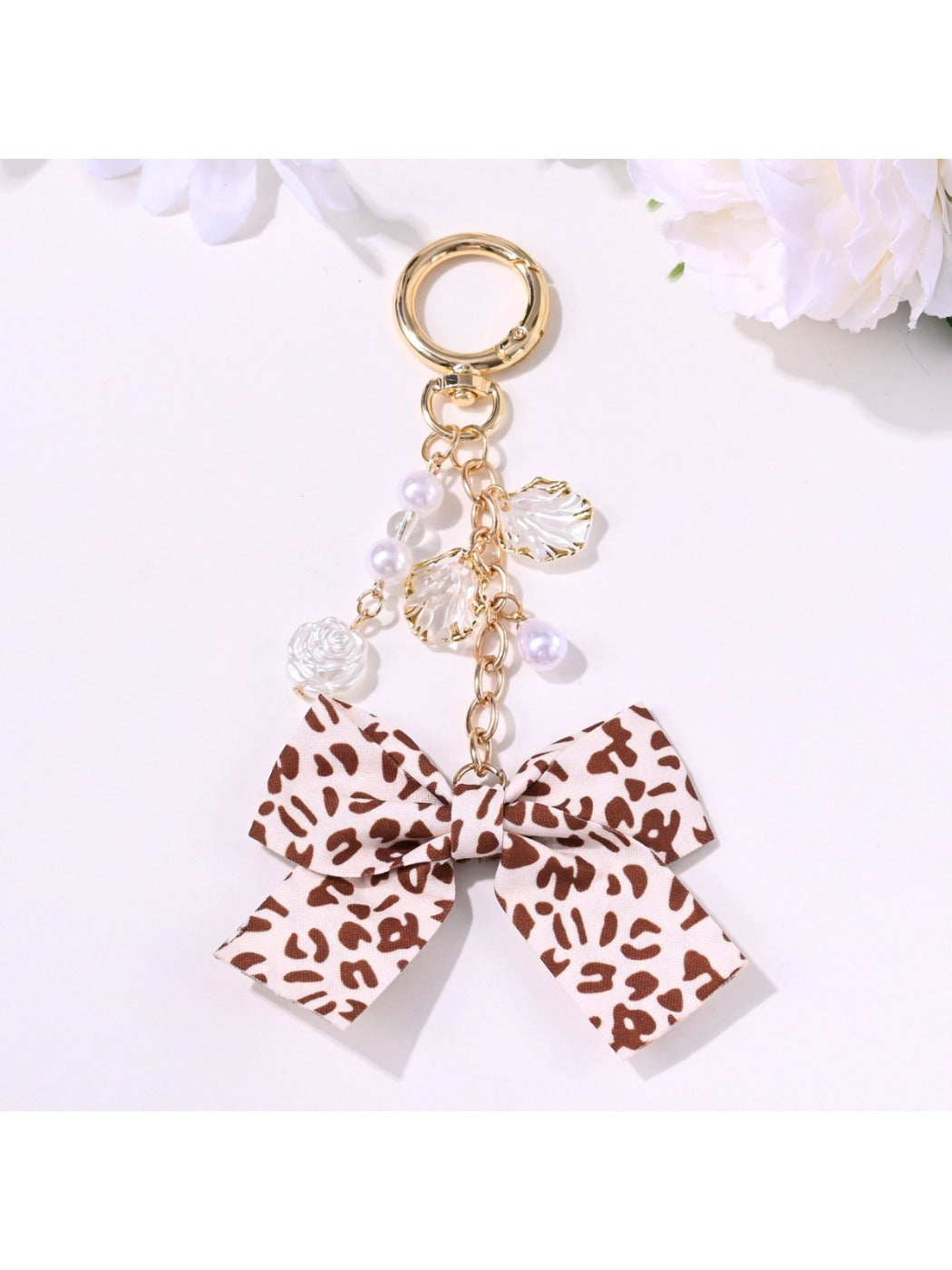 Side view of the pink bow rose pendant keychain showing its detailed petals
