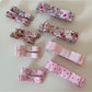Close-up of Beau pink floral pattern hair clip on white background