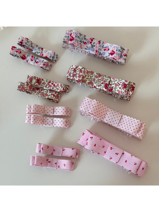 Close-up of Beau pink floral pattern hair clip on white background