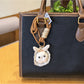 Close-up of bunny bag charm keychain showing detailed stitching and facial features