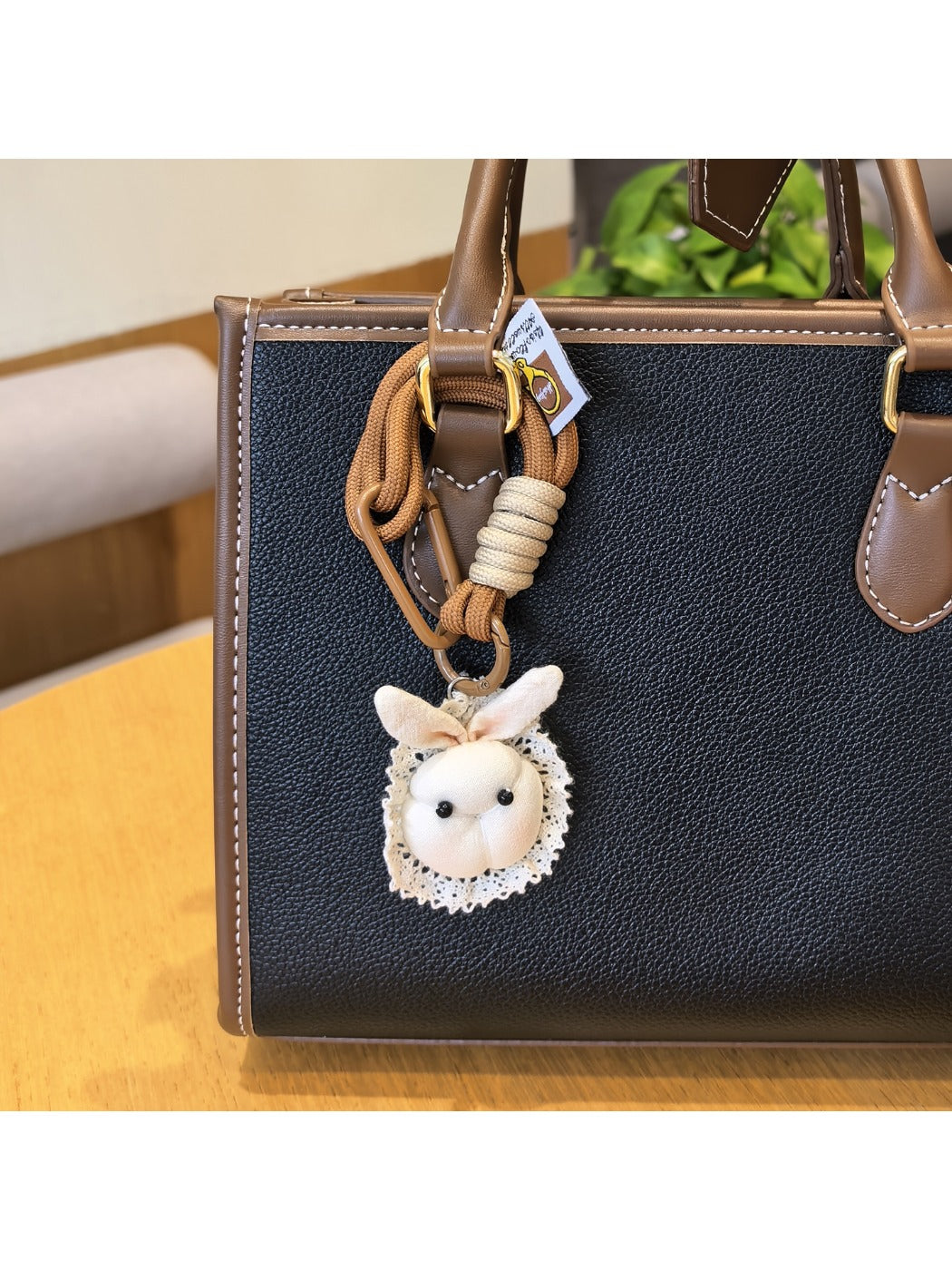 Close-up of bunny bag charm keychain showing detailed stitching and facial features