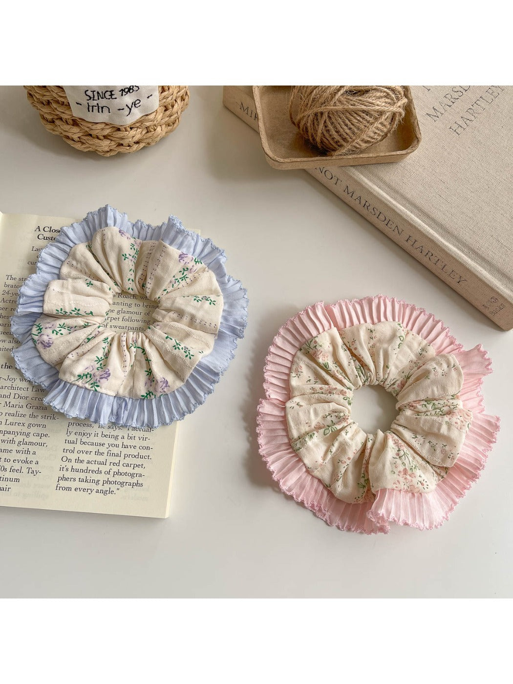 Close-up of Gifty ruffle scrunchie with tiny floral print on fabric