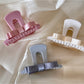 Beau T shaped bow hair claw clip in matte black on white background