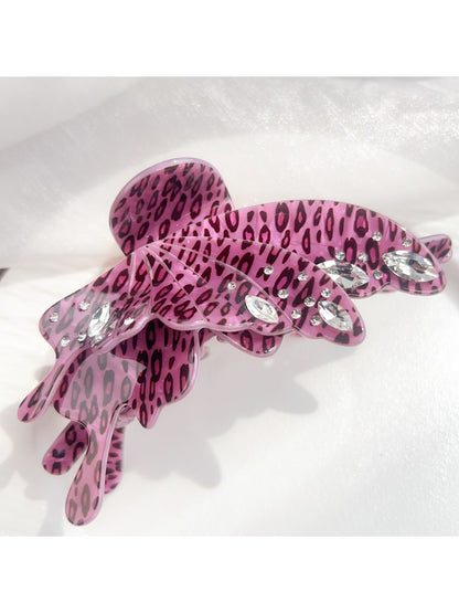 Beau leopard print butterfly claw clip next to matching accessories