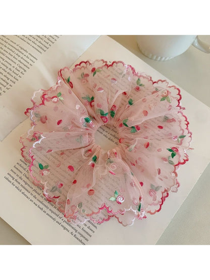 Pink double layered scrunchie worn on wrist as accessory