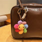 Close-up of Keypus cute flower charm keychain with pastel petals and gold ring