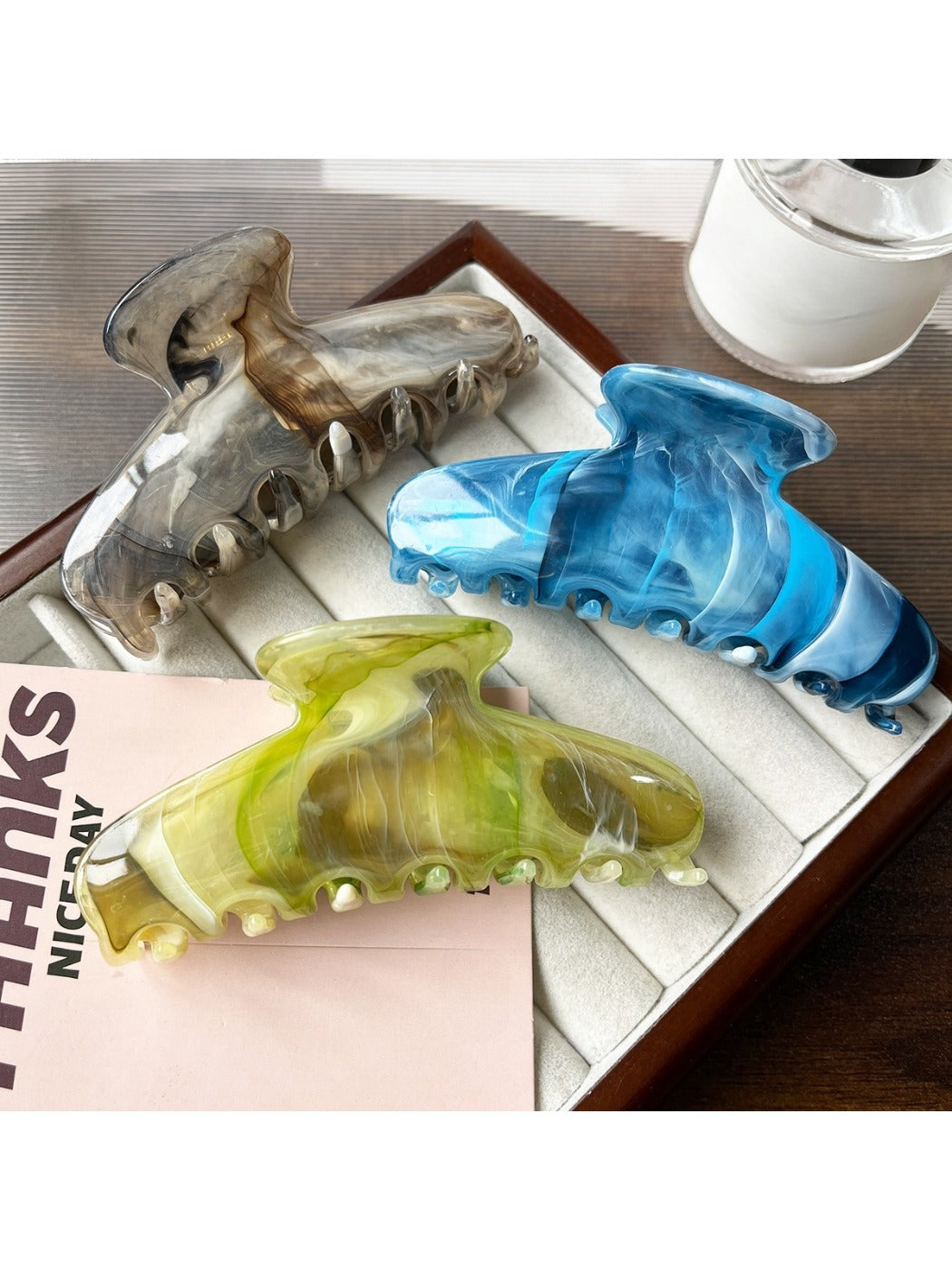 Close-up of the clasp and hinge of the beige Beau plastic updo claw clip