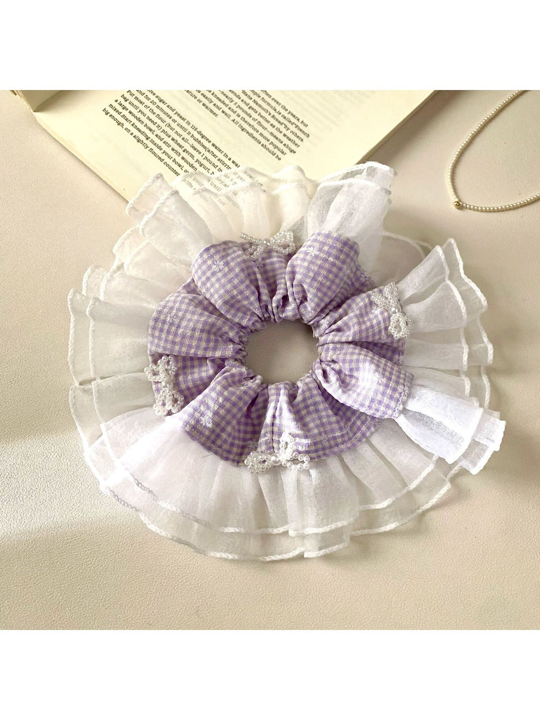 Gifty plaid scrunchie paired with casual outfit on a wooden surface