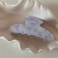 Beau tortoiseshell acetate claw clip displayed open showing spring mechanism