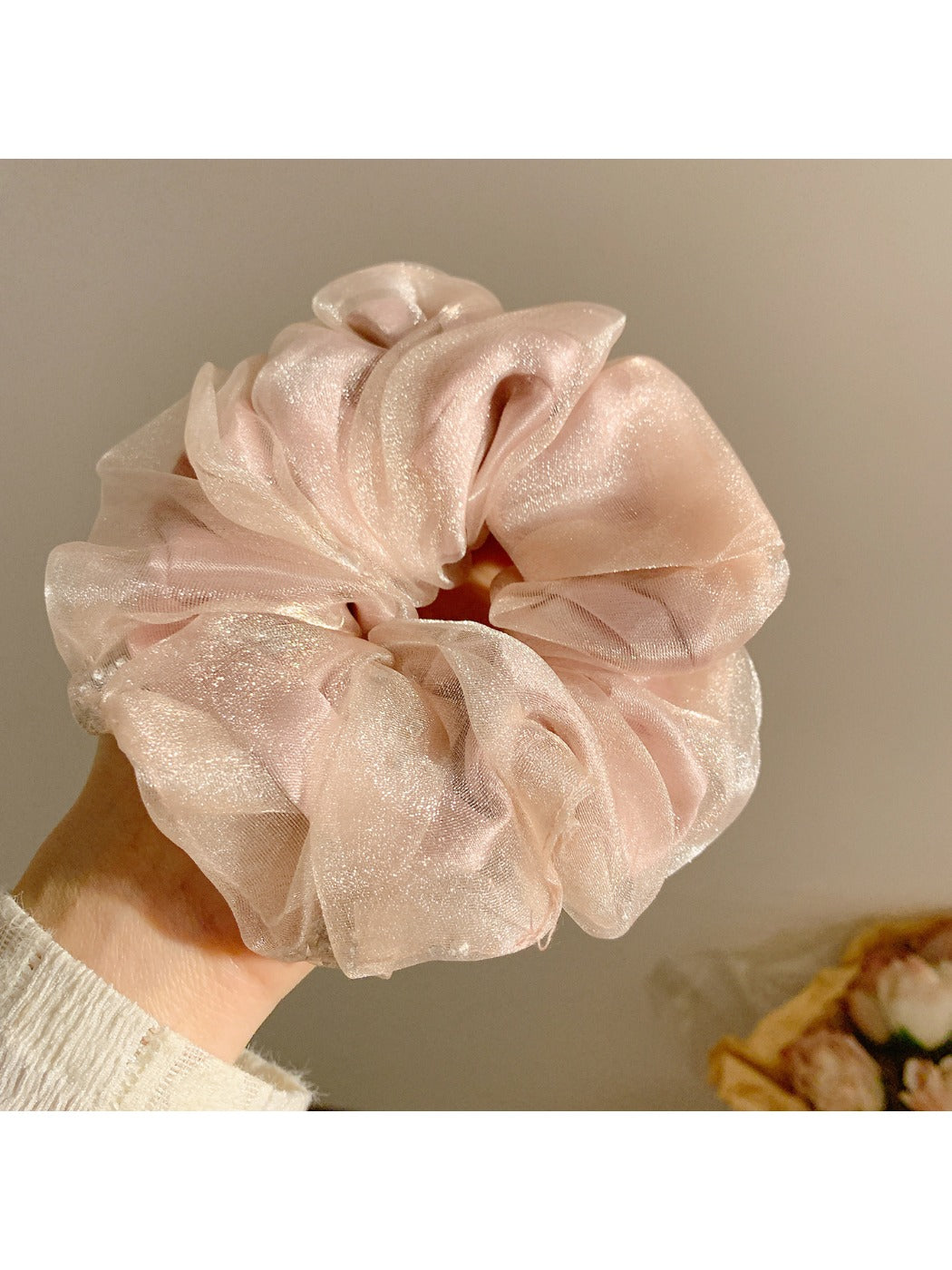 Scrunchie wrapped around a ponytail, emphasizing minimalist and cute style