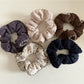 Close-up of Gifty trendy scrunchie with vibrant floral pattern on fabric