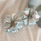 Blue ruffled scrunchie displayed on a white background
