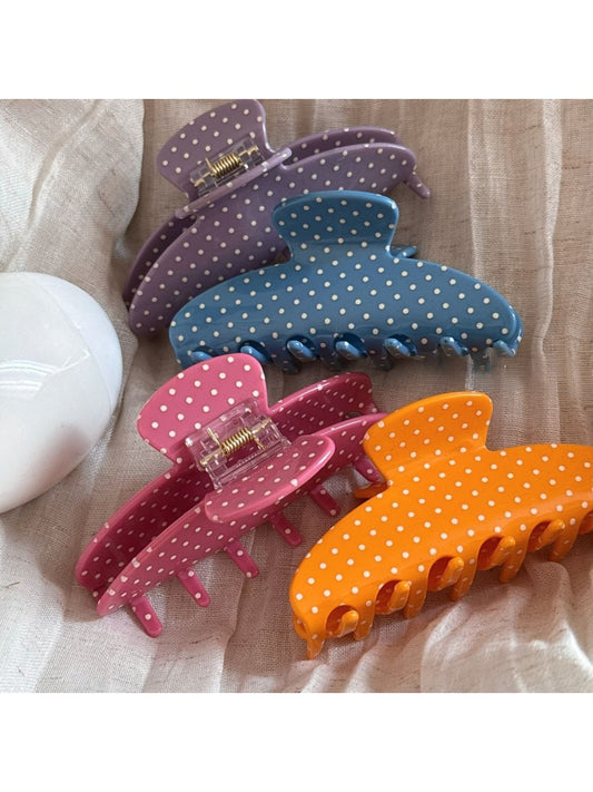 Beau colorful polka dot acetate hair clip on white background