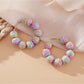 Earedge raffia round ball drop earrings styled with casual outfit on model