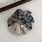 Side view of Gifty ruched scrunchie highlighting fabric texture
