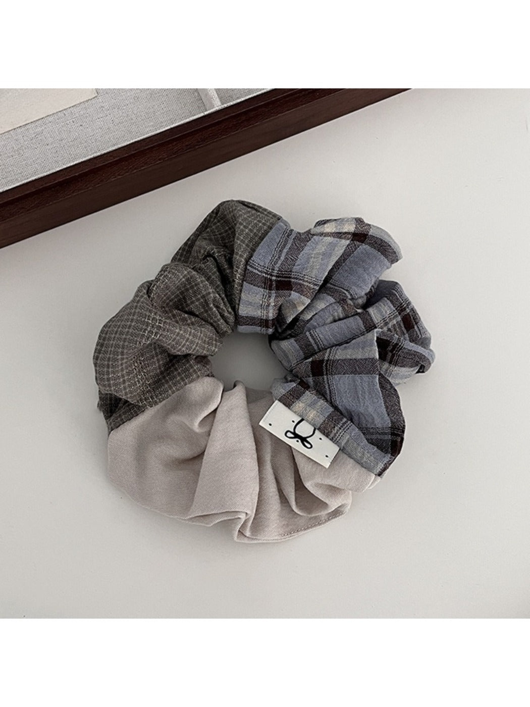 Side view of Gifty ruched scrunchie highlighting fabric texture