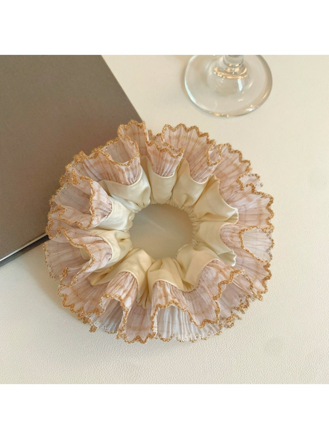 Close-up of Gifty satin hair scrunchie with delicate lace trim in soft pink