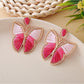 Earedge butterfly drop earrings styled with a casual outfit on a model