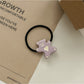 Close-up of rose hair clip clasp mechanism in soft pink color