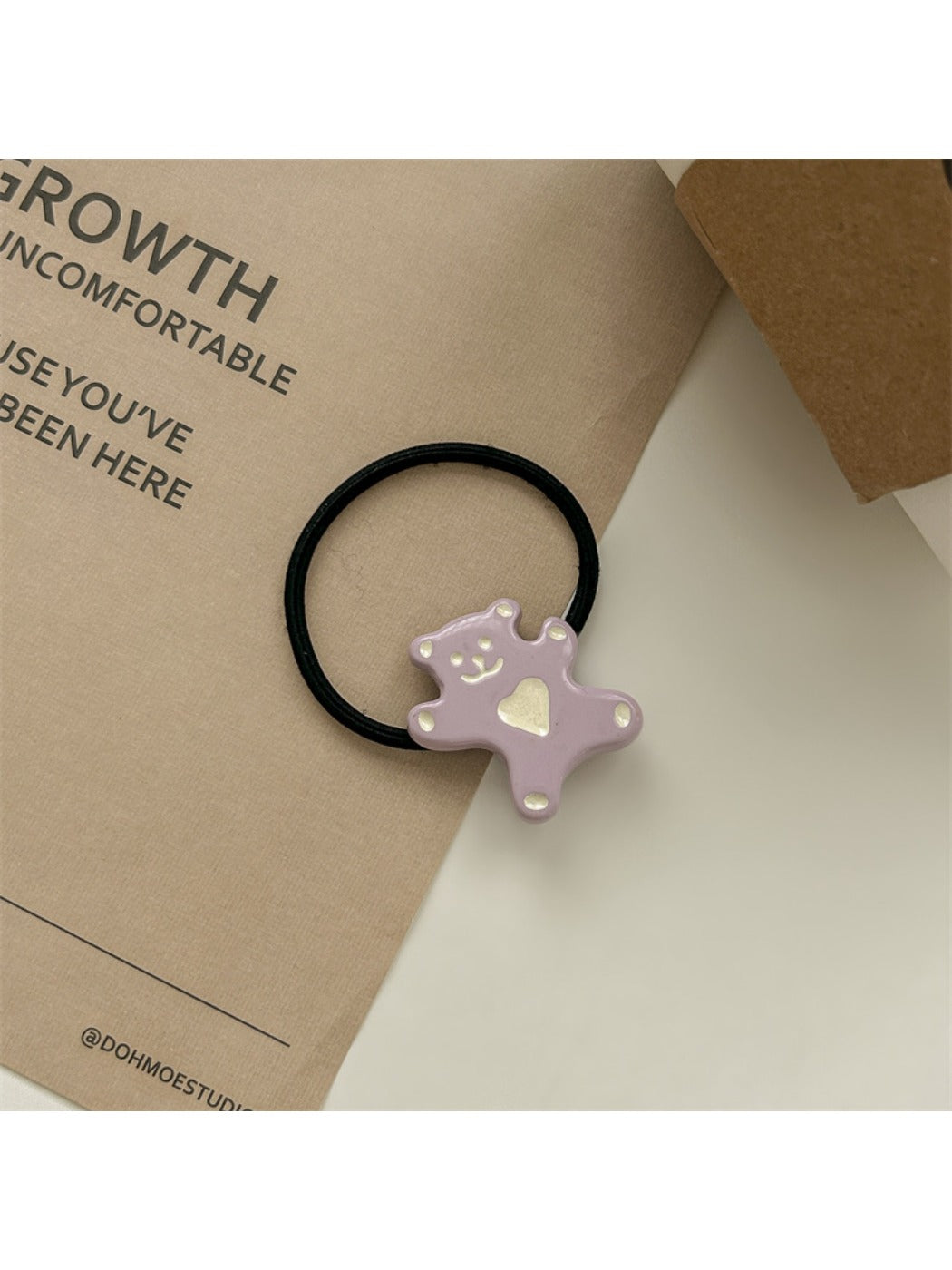 Close-up of rose hair clip clasp mechanism in soft pink color