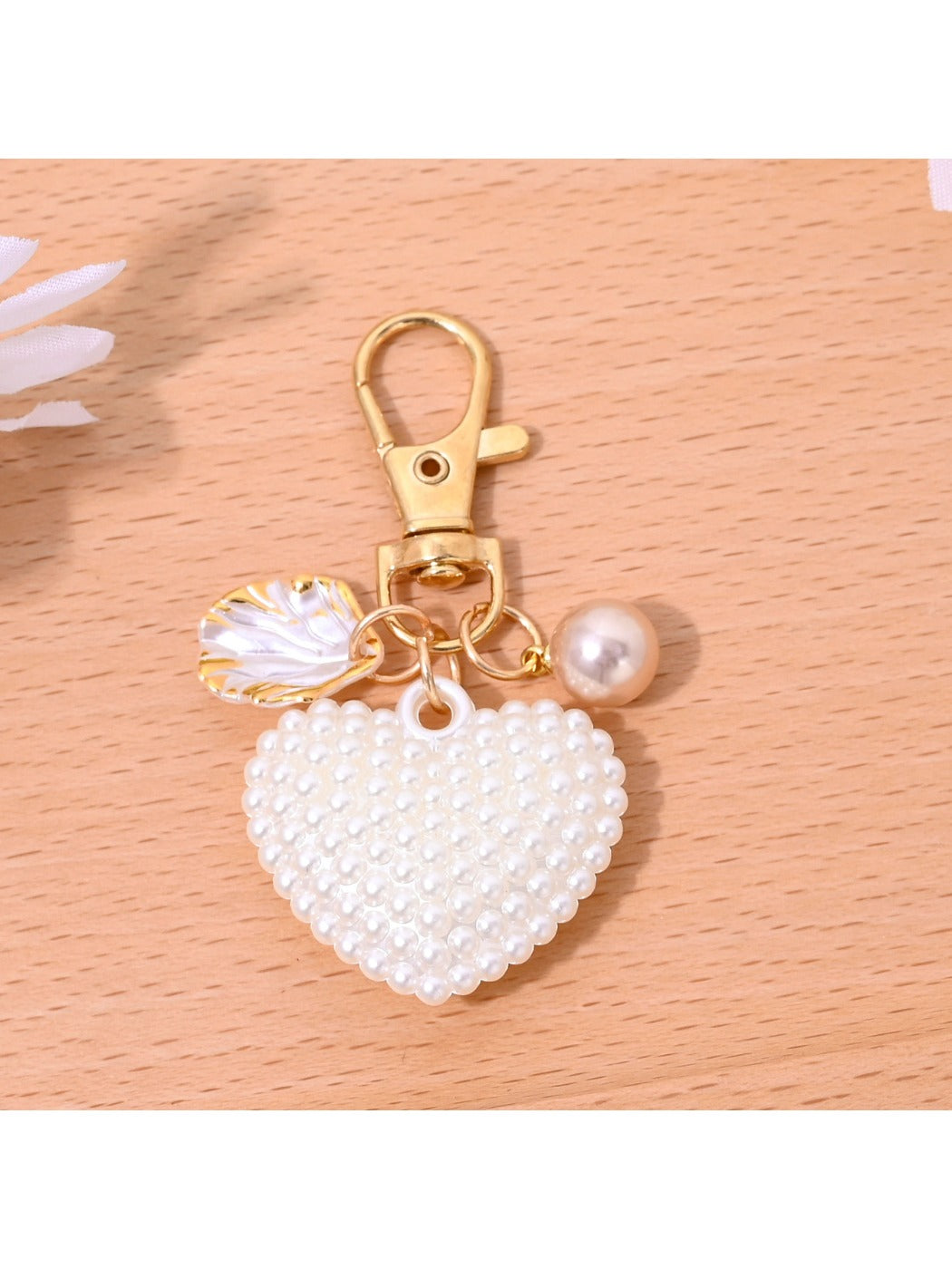 Red leather heart shaped bag charm keychain shown from top angle on flat surface