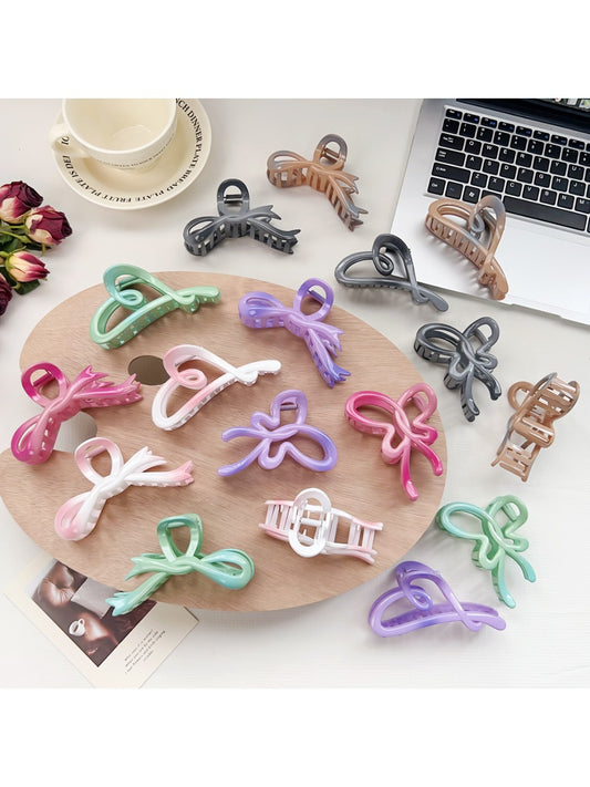 Beau ombre heart shaped bow claw clip in pink and purple gradient on white background