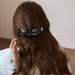 Close-up of Beau polka dot bow banana clip showing bow detail
