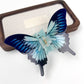 Beau butterfly hair claw clip shown from bottom to reveal teeth alignment