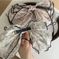 Beau floral bow hair clip displayed on a white background showing the clip mechanism