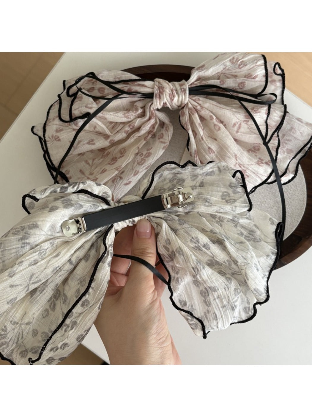 Beau floral bow hair clip displayed on a white background showing the clip mechanism