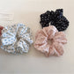 Side view of Gifty elegant floral scrunchie highlighting gathered fabric and floral print details