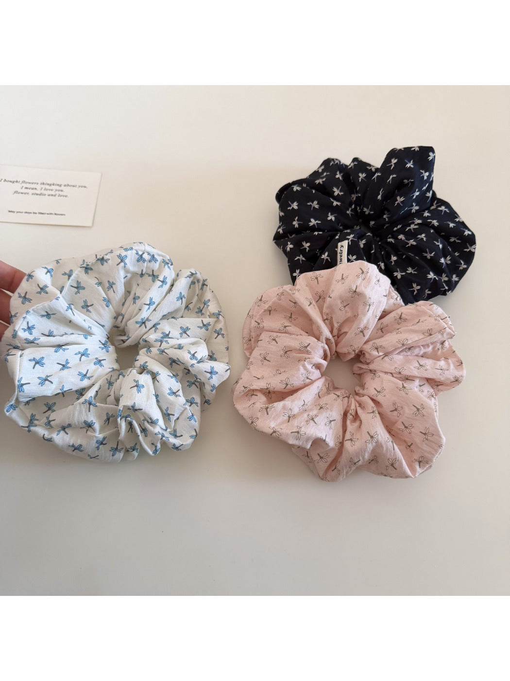 Side view of Gifty elegant floral scrunchie highlighting gathered fabric and floral print details