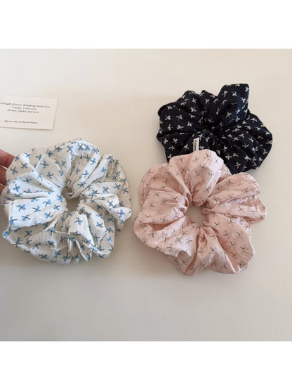 Side view of Gifty elegant floral scrunchie highlighting gathered fabric and floral print details