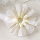 Elegant white silky scrunchie with smooth texture on a plain background