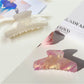 Beau gradient half moon hair claw clip with metal spring mechanism visible