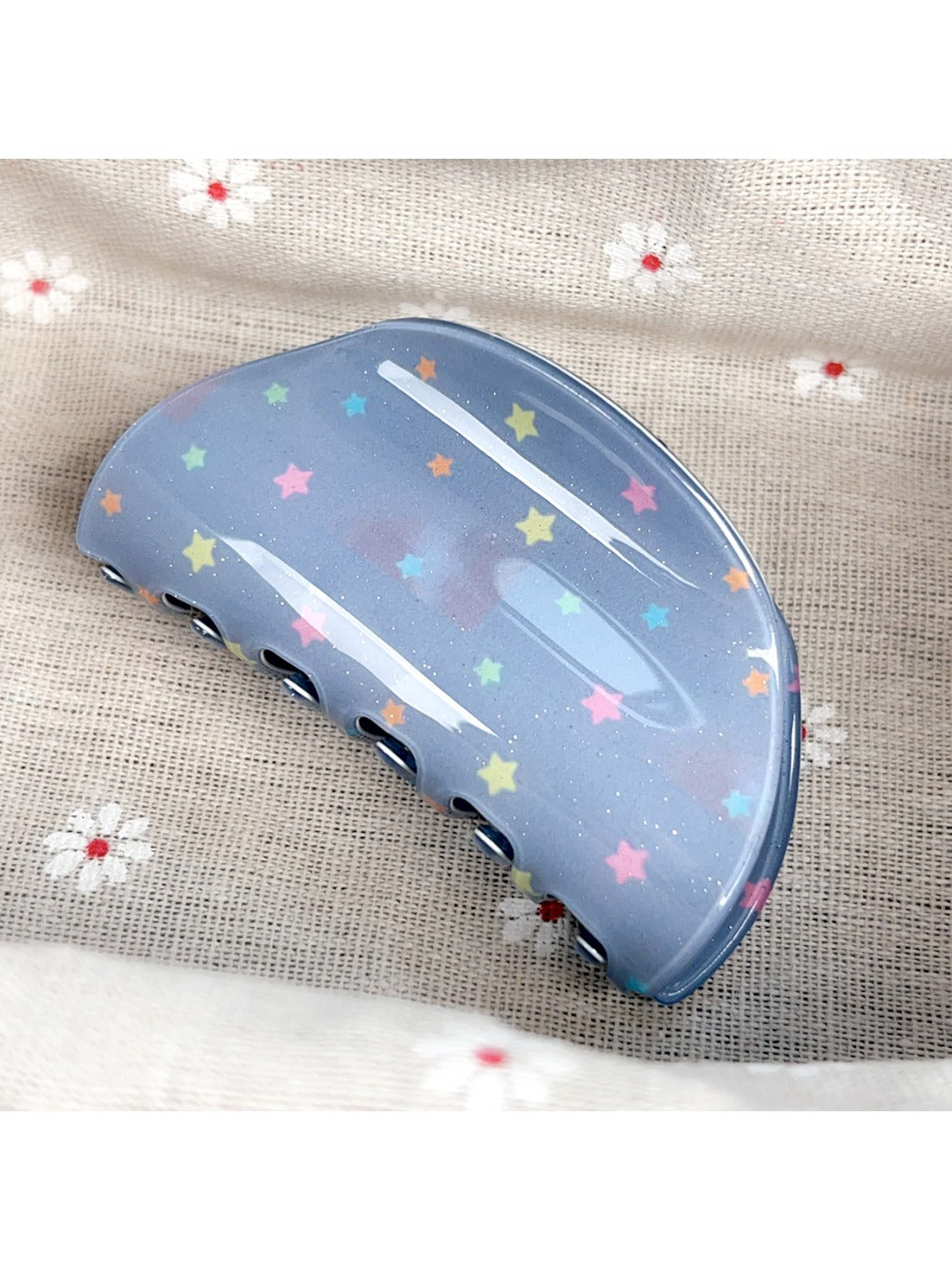 Blue star print hair claw clip open showing inner teeth