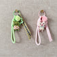 Close-up of fabric animal keychain showing texture and colorful stitching on soft material