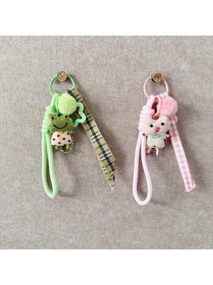 Close-up of fabric animal keychain showing texture and colorful stitching on soft material