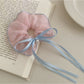 Gifty scrunchie worn on a wrist, highlighting its size and ruffled design
