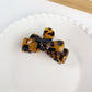 Beau bow shaped hair claw clip displayed with natural lighting