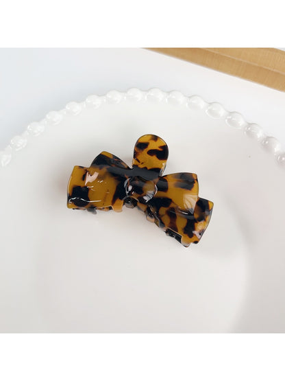 Beau bow shaped hair claw clip displayed with natural lighting