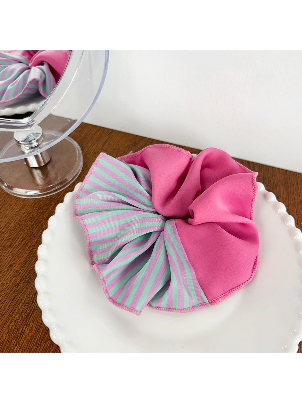 Scrunchie displayed flat highlighting magenta and pink stripes