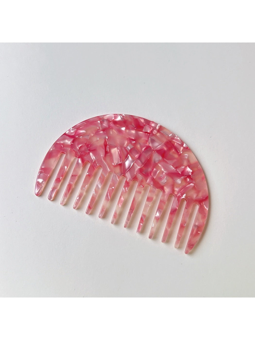 Camerow hair comb resting on a wooden surface with natural light